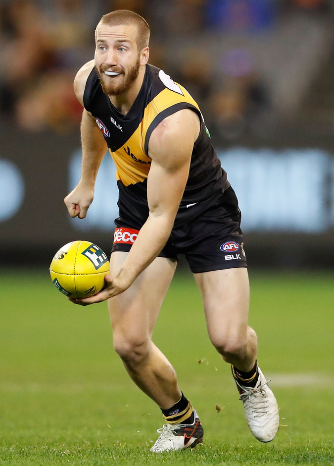 AFL 2016 Rd 12 - Richmond v Gold Coast MELBOURNE, AUSTRALIA - JUNE 12: Kane Lambert of the Tigers handpasses the ball during the 2016 AFL Round 12 match between the Richmond Tigers and the Gold Coast Suns at the Melbourne Cricket Ground on June 12, 2016 in Melbourne, Australia. (Photo by Adam Trafford/AFL Media)